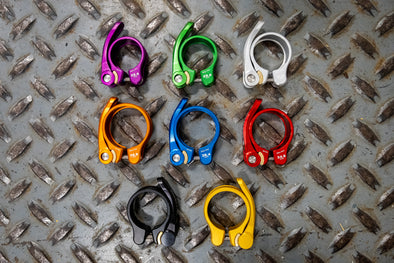 Blue, Black, Gold, Silver, Green, and Red Wolf Tooth QR Seatpost Clamps
