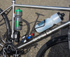 Otso bike with 2 water bottle cages, a tool roll, and a spare tube mounted with the Wolf Tooth B-RAD mounting system