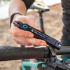 Wolf Tooth 8-Bit Pack Pliers used to tighten brake clamp