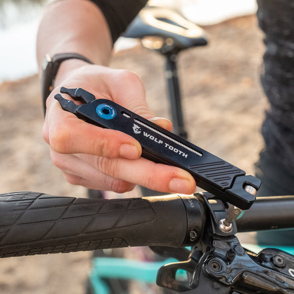 Wolf Tooth 8-Bit Pack Pliers used to tighten brake clamp