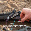 Wolf Tooth 8-Bit Pack Pliers used to loosen valve core