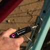 Wolf Tooth 8-Bit Pack Pliers used to tighten water bottle cage bolt
