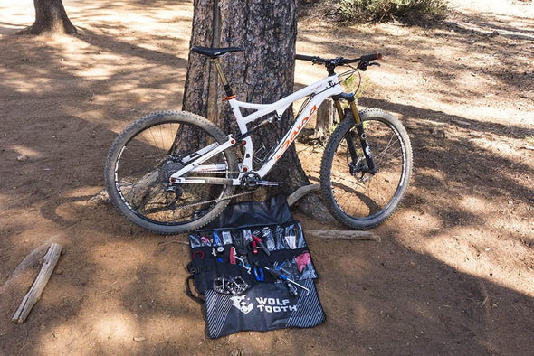 Wolf Tooth Travel Tool Wrap in use on ground with tools