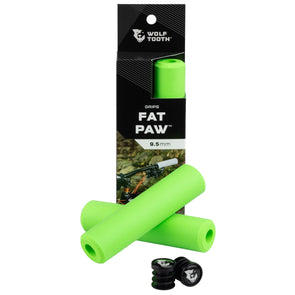 Wolf Tooth Fat Paw handlebar grips in green both in packaging and sitting in front of packaging with bar end plugs