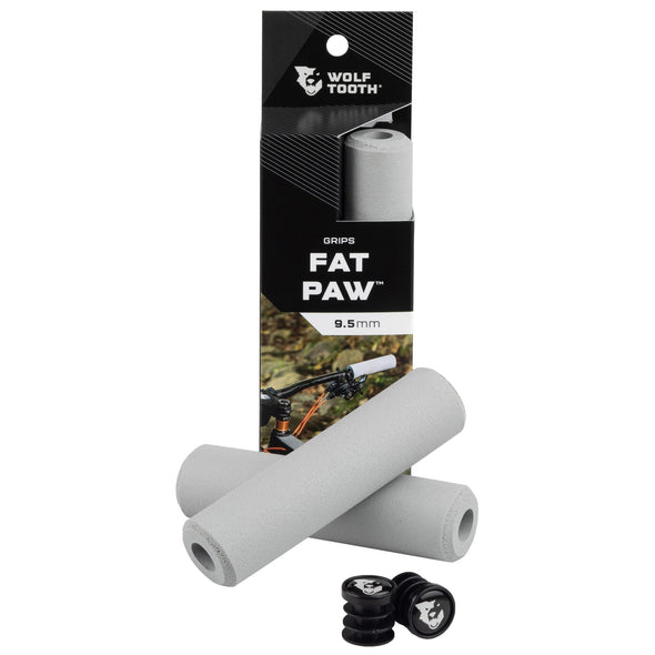 Wolf Tooth Fat Paw handlebar grips in grey both in packaging and sitting in front of packaging with bar end plugs