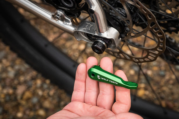 Wolf Tooth Axle Handle Multi-tool removes axle and stores bits for trailside repairs. Also stores on bike using Wolf Tooth rear threaded axle. Best trailside axle handle tool to remove wheel to fix flat tire or place on bike rack