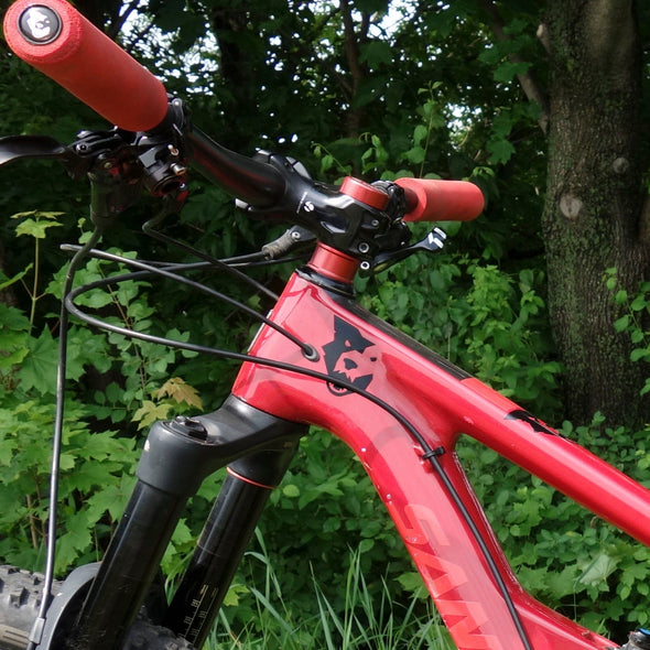 Black Wolf Tooth wolf head sticker on red Santa Cruz mountain bike